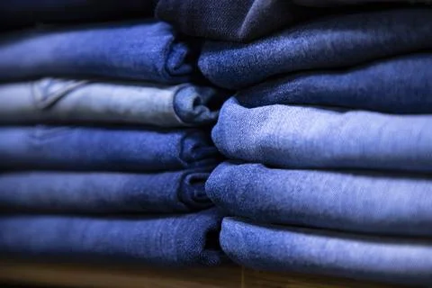 Folded blue jeans pant pattern texture. Selective Focus Stock Photos