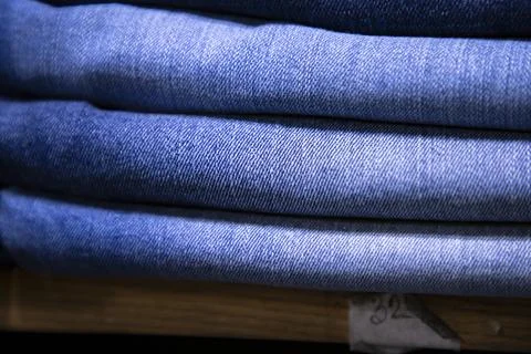 Folded blue jeans pant pattern texture. Selective Focus Stock-Fotos