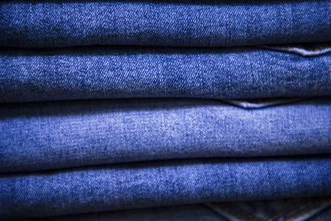 Folded blue jeans pant pattern texture. Selective Focus Stock Photos