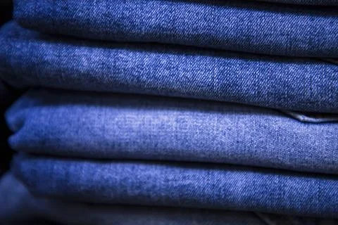 Folded blue jeans pant pattern texture. Selective Focus Stock Photos