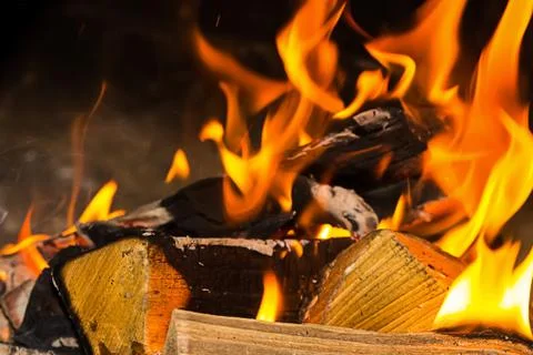 Folded bonfire firewood part of a solid log bright orange bright flame Stock Photos