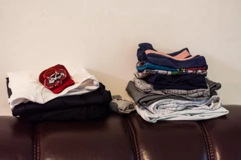 Folded clothes on the sofa Stock Photos