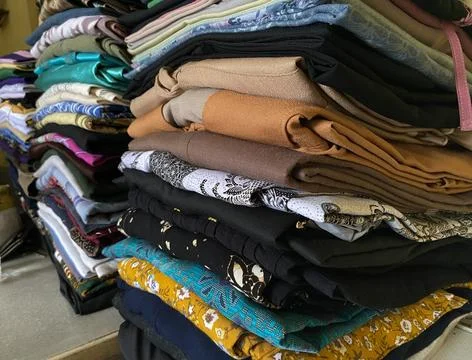 Folded clothes on the table landscape Stock Photos