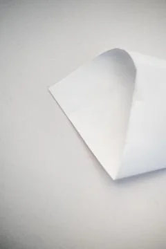 Folded Corner of White Paper on Textured Surface Stock Photos