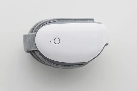 Folded eye massager on white background. Top view. Stock Photos