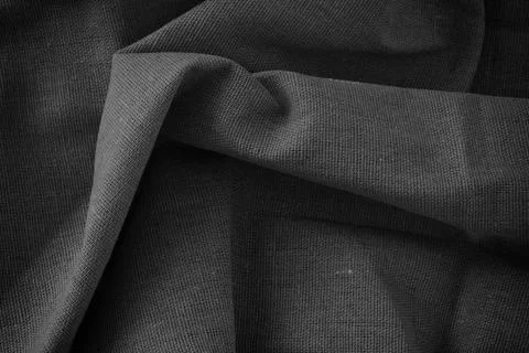 Folded fabric texture background. Black and white. Stock Photos
