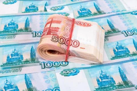 Folded five thousandths banknotes of russian roubles over banknotes backgroun Stock Photos