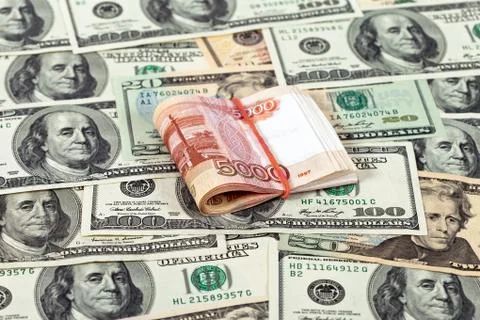 Folded five thousandths rouble bills on dollars background Stock Photos