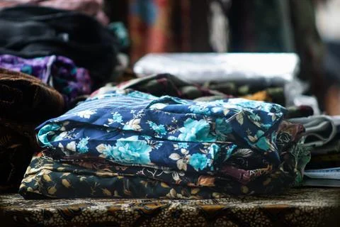 Folded Floral Batik Cloth Stack on Table for Background Stock Photos