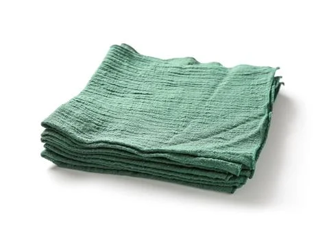 Folded green muslin cloth stack, soft textured fabric for kitchen or home use Stock Photos