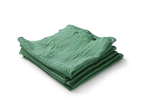 Folded green muslin cloth stack, kitchen textile, home decor, and cleaning su Stock Photos