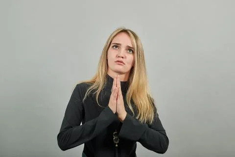 Folded hands together praying asking God help ask implore wish upwards Jesus . Stock Photos