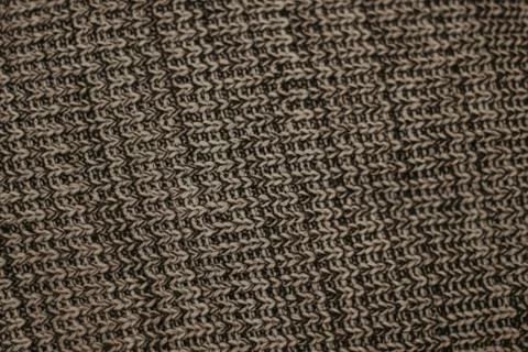 Folded knitted woolen sweaters, stack of old books on a cozy fluffy beige bla Stock Photos