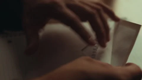 Folded Letter Placed In Envelope in a Dim Office Stock Footage 263901333