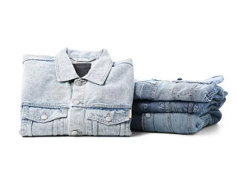 Folded light blue denim jacket and stack of dark blue jeans, casual fashion a Foto stock