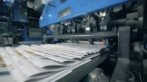 Folded magazines are being released by the machine Video stock 111366493
