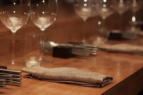 Folded napkin laid on the table for dinner at restaurant with vintage color s Stock Photos