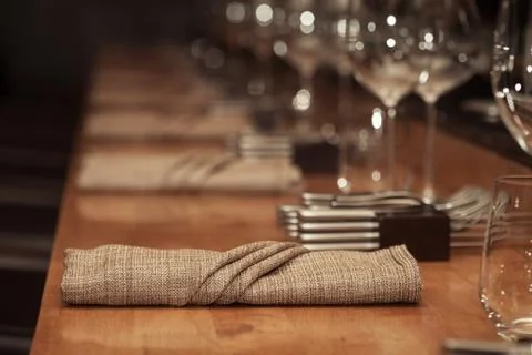 Folded napkin laid on the table for dinner at restaurant with vintage color s Stock Photos