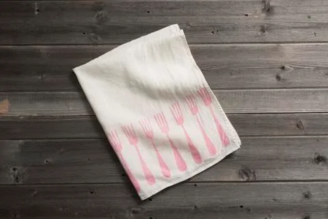 Folded Napkin with Pink Fork Pattern on Wooden Surface Stock Photos