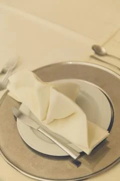 Folded napkins on a dinner table Stock Photos
