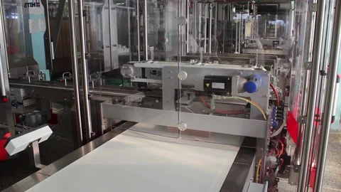 Folded, one on another, wafer tiles move along a conveyor belt. Stock Footage 122336326