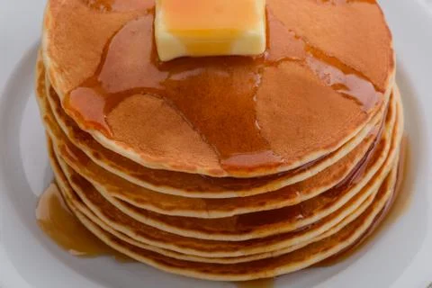 Folded pancakes with maple syrup Stock Photos
