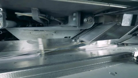 Folded paper is getting transported onto the conveyor belt Stock Footage 105150200