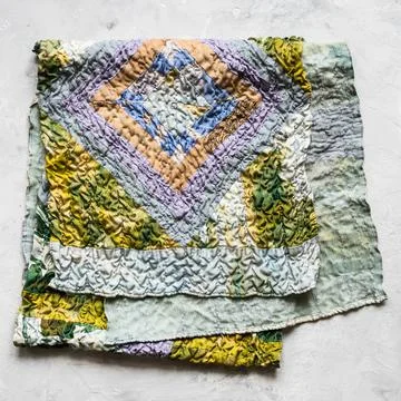 Folded patchwork scarf sewn from silk fabrics Stock Photos