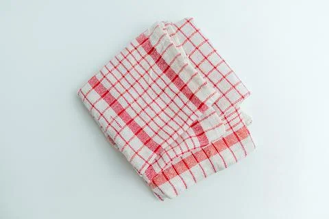 Folded red and white checkered kitchen cloth napkin isolated on a white bac.. 库存照片