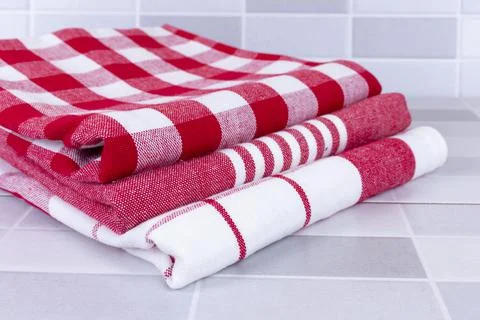 Folded red checkered picnic kitchen towels on a table Stock Photos