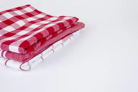 Folded red checkered picnic kitchen towels on grey Stock Photos