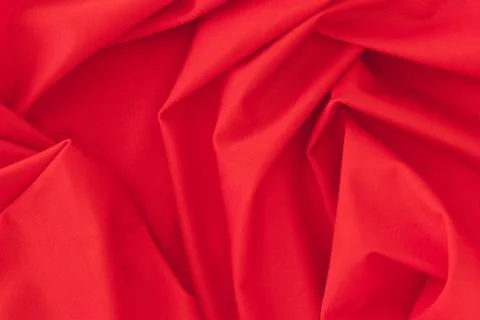 Folded red textile fabric texture background Stock Photos