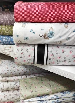 Folded rolls of multi-colored lightweight fabric with expressive texture Stock Photos