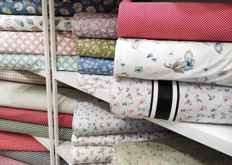 Folded rolls of multi-colored lightweight fabric with expressive texture Stock Photos