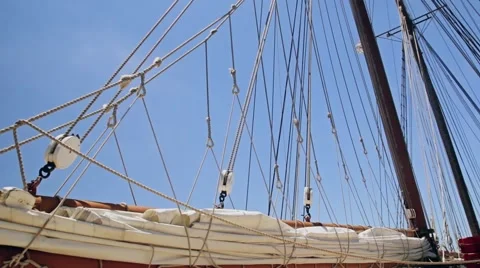 Folded sail and rigging of a sailboat against the sky Video stock 64578985