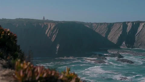 Folded sea cliffs with Cabo Sardao lighthouse on top, Portugal Stock Footage 346479894