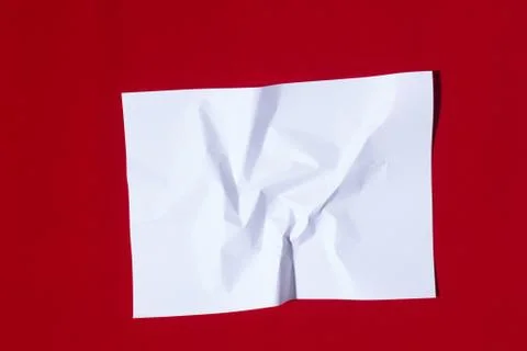 Folded sheet of paper on a red background Stock Photos