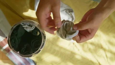 Folded socks being stored inside a plastic container. 動画素材 331761270