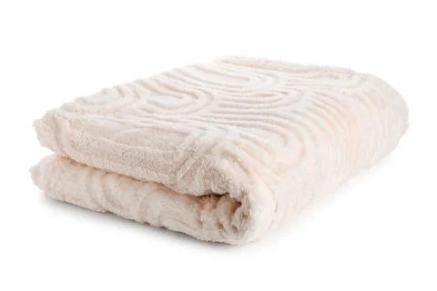 Folded soft beige plush blanket with embossed swirl pattern, cozy home textil Stock Photos