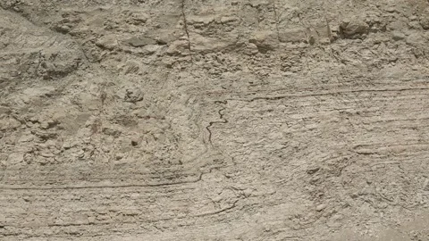 Folded soil layers reveal erosion marks in cross section, exposed - Soil Strata Stock Footage 339814862