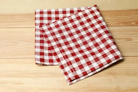 Folded tablecloth with checkered pattern on light wooden table, top view Stock Photos