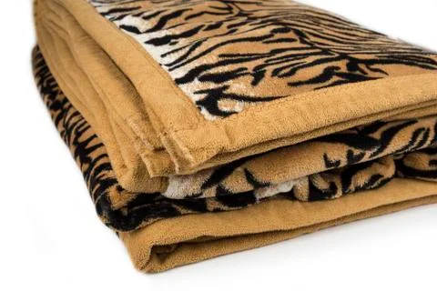 Folded tiger pattern blanket on a white background Stock Photos