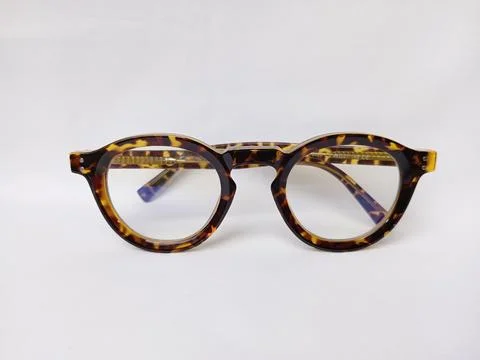 Folded tiger pattern eyeglass on a white background. Stock Photos