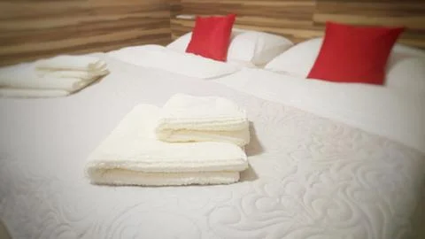 Folded towels on the bed Fotos Stock