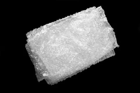 Folded transparent bubble wrap on black background, top view Stock Photos
