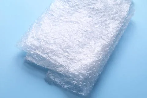 Folded transparent bubble wrap on light blue background, closeup Foto stock