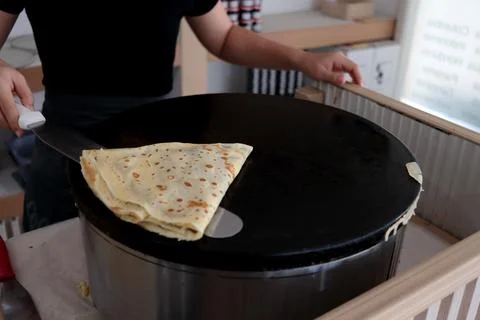 Folded triangle shape crepe on black hot plate. Stock Photos