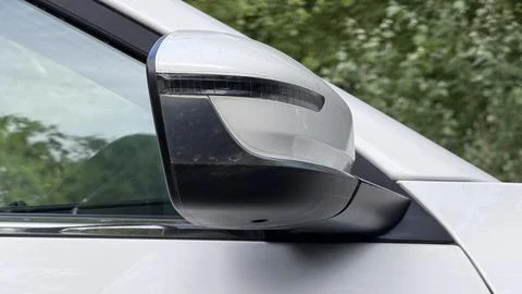 Folded white side rearview mirror with integrated turn signal indicator on a Stock Photos