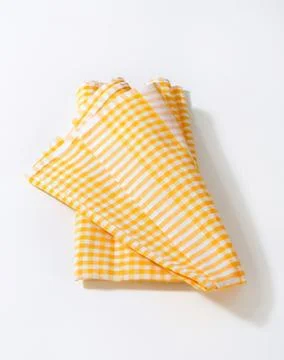 Folded yellow and white checkered cloth napkin 스톡 사진