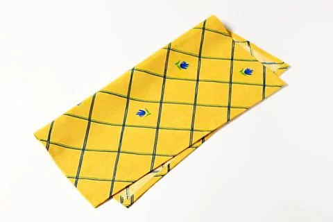 Folded yellow checkered cloth with blue bird prints Foto stock